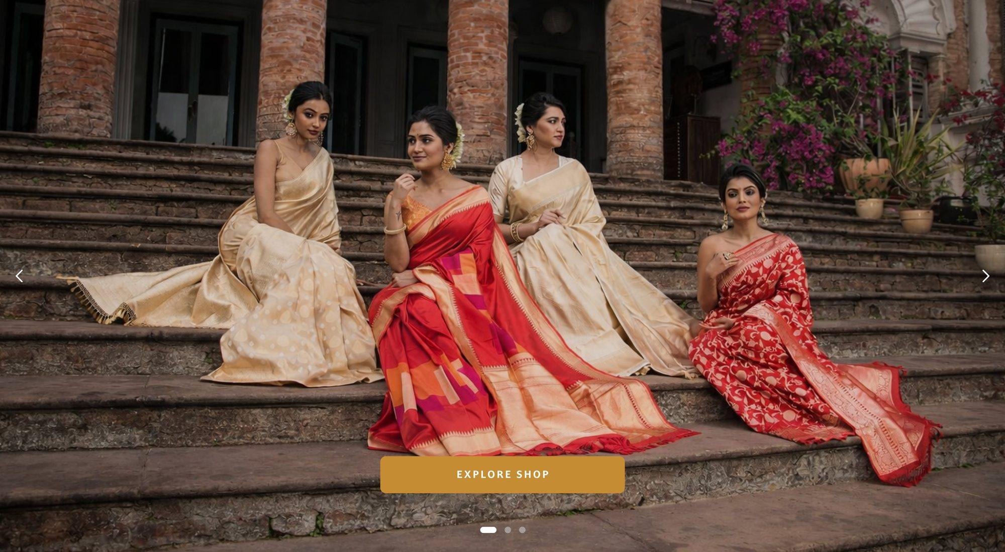 Four women in Banarasi silk sarees on old stone steps